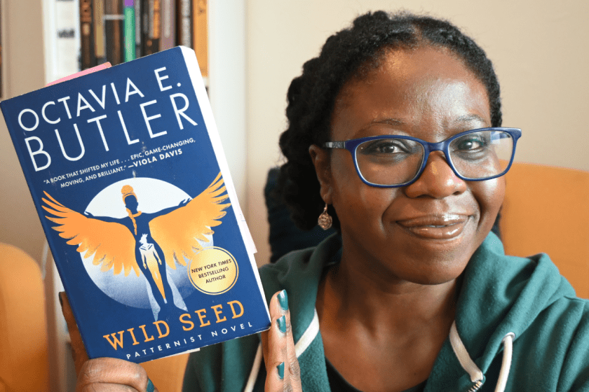 Shade holding copy of Octavia Butler's Wild Seed.