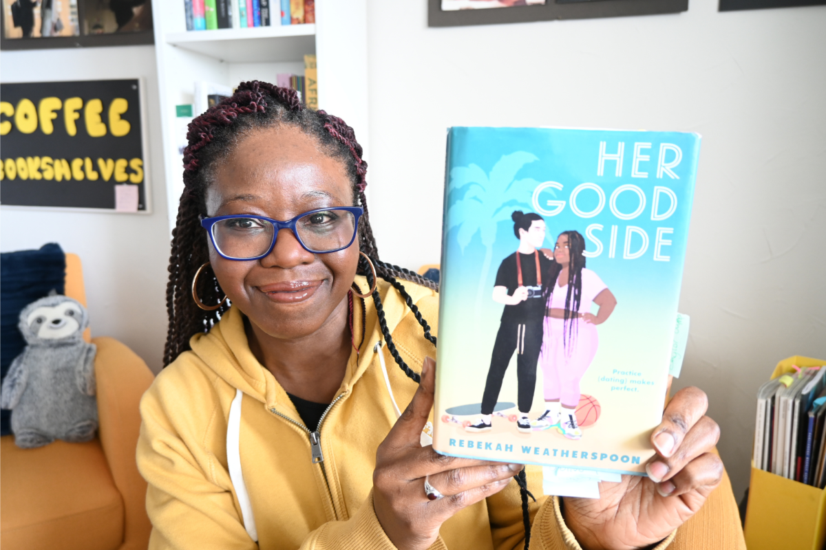 Shade holds copy of novel, Her Good Side.